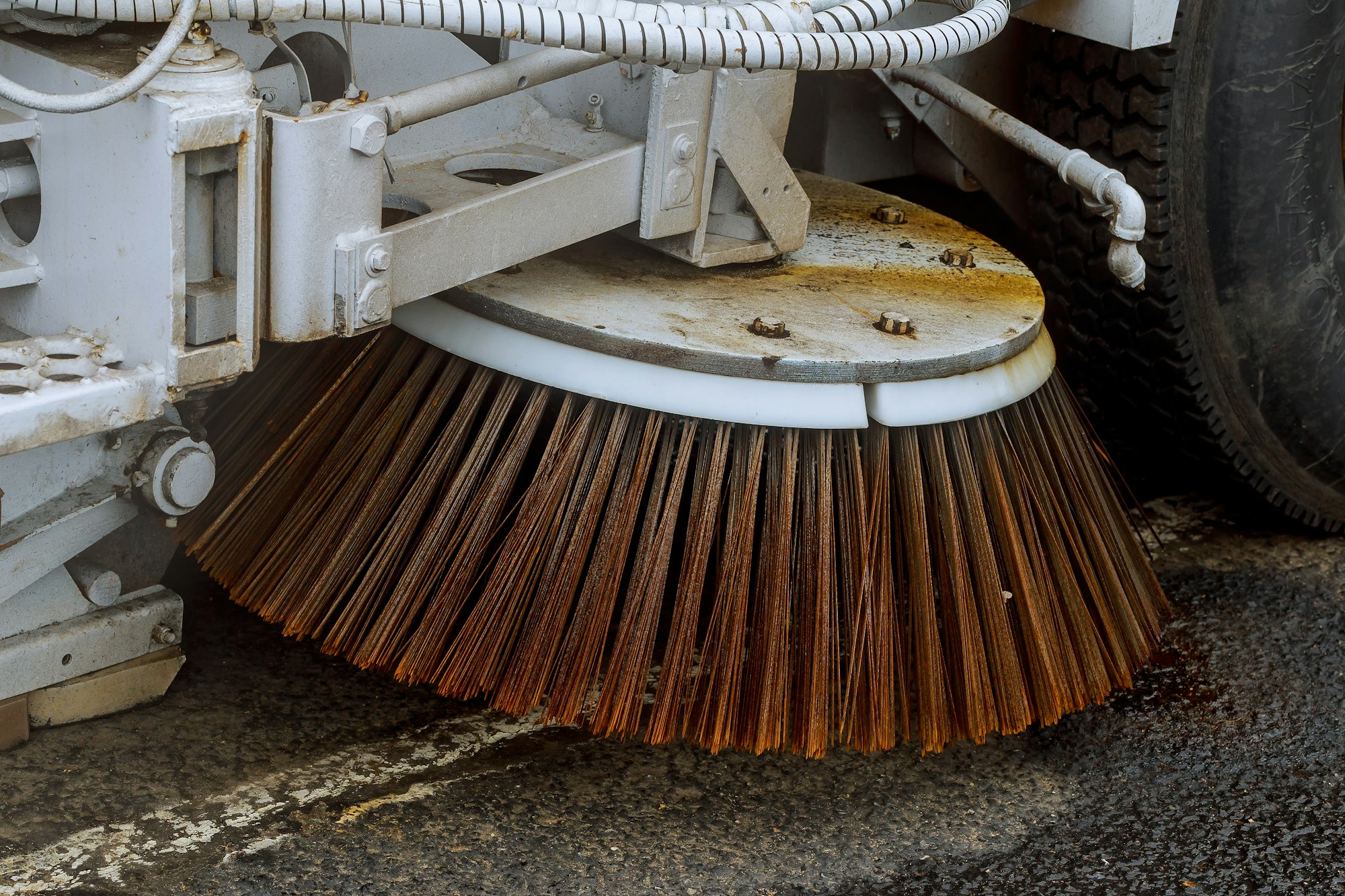 Close up road sweeper machine cleaning city street Cleaning streets